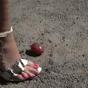 Hot babe crushes and squishes tomatoes outside in the park.