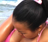 Asian teen Joon in see through pink bikini plays in the ocean