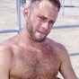 This sexy stud is getting naked out by the corrals