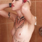 exotic tattooed and pierced beauty in the shower