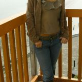 Beautiful Carla relaxes on a balcony in casual clothes including tight jeans, boots and thong.