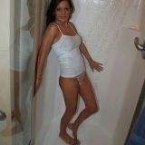 Comely brunette teen Kate Krush showing her assets under the shower