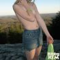 Sensual blonde teen in jeans skirt Kitty Kim strips and shows assets on the mountain