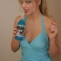 Jana enjoys a soda while she strips out of her little cute outfit