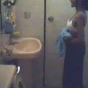 Mature housewife taking her clothes off in shower