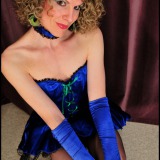 Costumed tranny masked in blue shows stiff cock & black nylons under black lace petticoat.