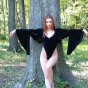 Stripper in black velvet casts sexy magic spell outside in the woods.