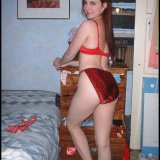 Panty-selling webcam girl models her shiny underwear & satin slip.