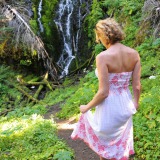 Pretty Delia by waterfall erect under her dress