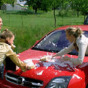 Three sweethearts fooling around with car water