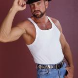 Hot bear cowboy Phil takes off his clothes to stroke his huge erection