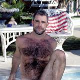 Hairy gay bear model totally naked in the pool and man handling his thick shaft