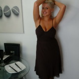 Emily comes home from a night out to strip out of her tight black dress