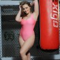 Jodie at the punching bag her pink bodysuit