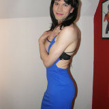Pretty crossdresser wearing a sultry blue dress and showing her tight figure
