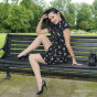 Hot babe Maria poses out in the park wearing a lovely dress with silky nylons and tall black stilettos