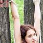 Girl tied to trees stripping