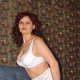 Mature businesswoman in hot striptease action