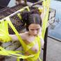 A girl is tied by yellow tape on a construction pitch