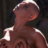 Bald girl in bustier shows off